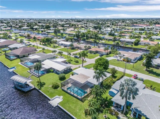 Bird's eye view featuring a water view, Cantilever dock  ready for your boat to tie up and large deep pool and new pool cageSuper waterfront neighborhood with walking/bike path to the River