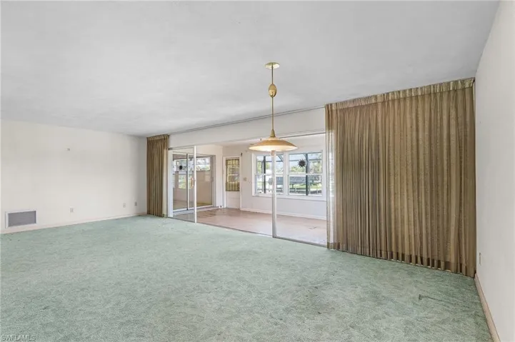 Great Room with sliders to the Florida Room and pool access