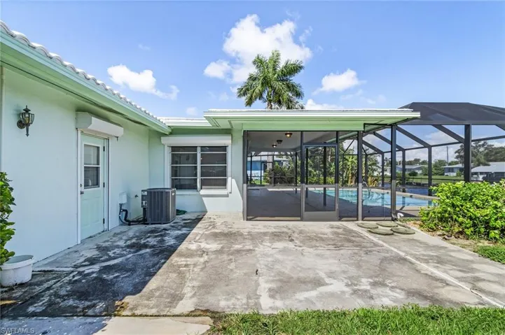 Huge side patio for outdoor BBQ or taking in the full Southern Exposure of the property. Door from the garage makes it easy to access pool and boat gear/toys  Air conditioner replaced 2020. concrete walkway to front of home