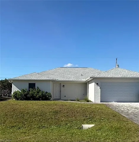 Single story home with a front lawn, stucco siding, decorative driveway, an attached garage, and roof with shingles