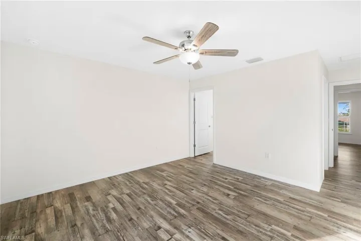 Empty room featuring wood finished floors and ceiling fan