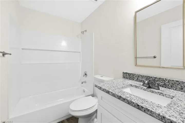 Full bath with washtub / shower combination and vanity