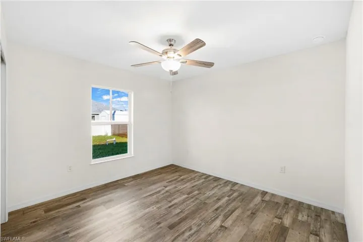 Spare room featuring wood finished floors and ceiling fan
