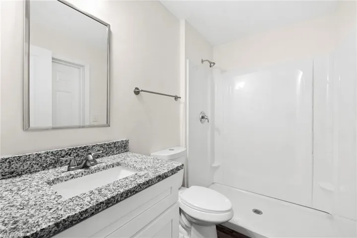 Full bathroom with vanity and a shower