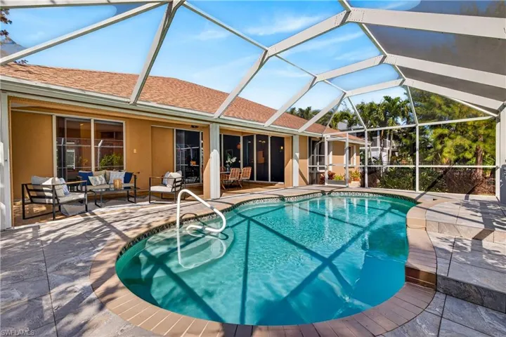 Outdoor pool with a patio area, a lanai, a sunroom, and outdoor seating