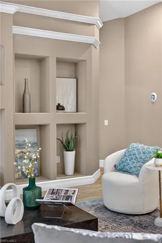 Sitting room with built in shelves and wood finished floors