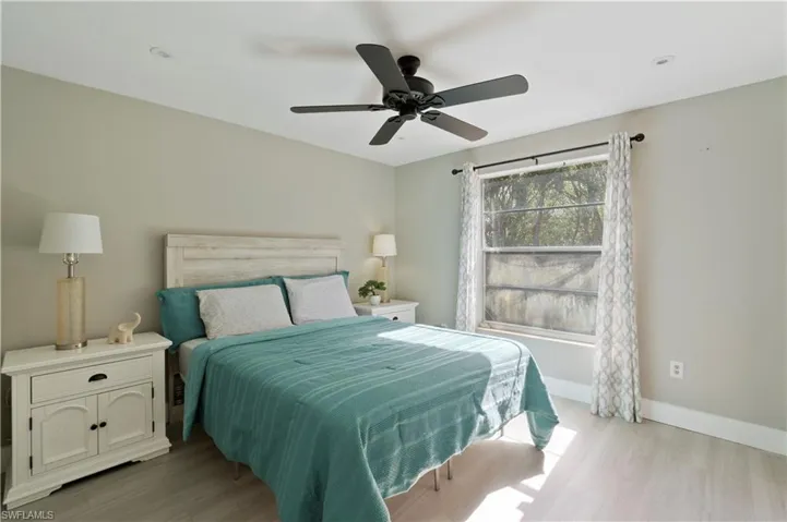 Bedroom with a ceiling fan and light wood-style floors