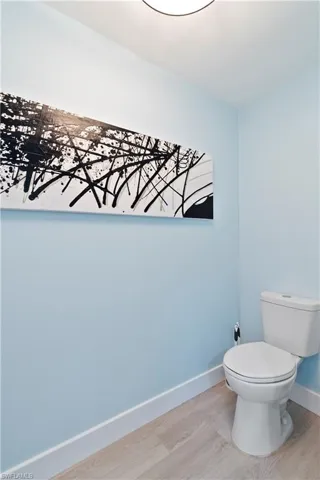 Bathroom with toilet and light wood-type flooring