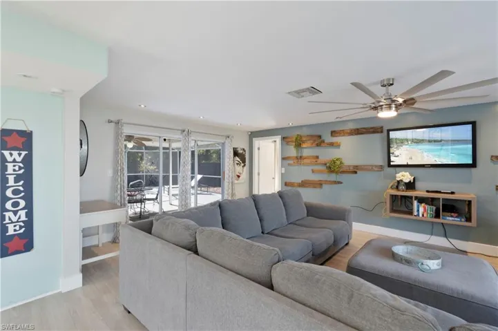 Living room featuring a ceiling fan and light wood-type flooring