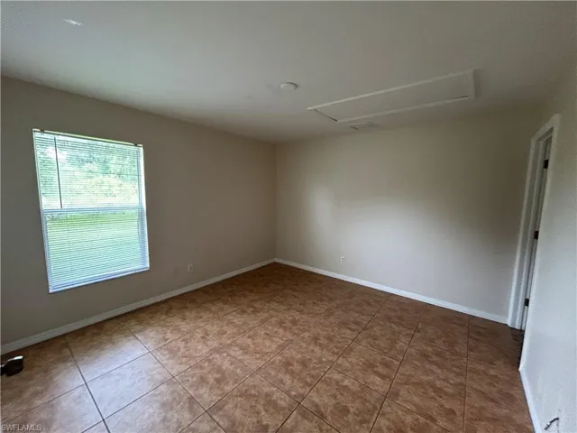 Spare room with tile patterned floors and baseboards