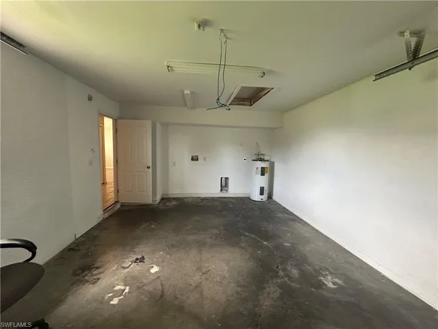 Garage featuring electric water heater