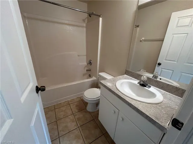 Full bath featuring vanity, tile patterned floors, and shower / bathtub combination