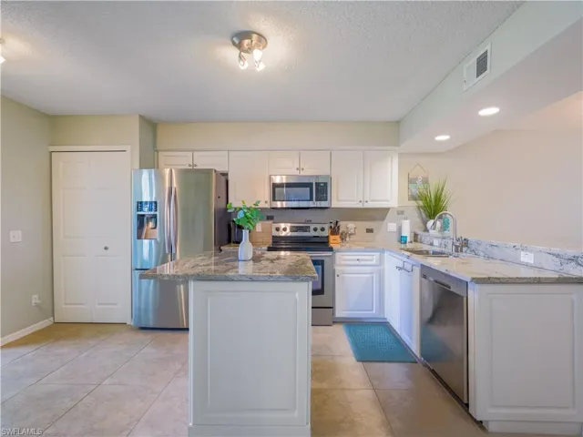 Kitchen with stainless steel appliances, granite countertops