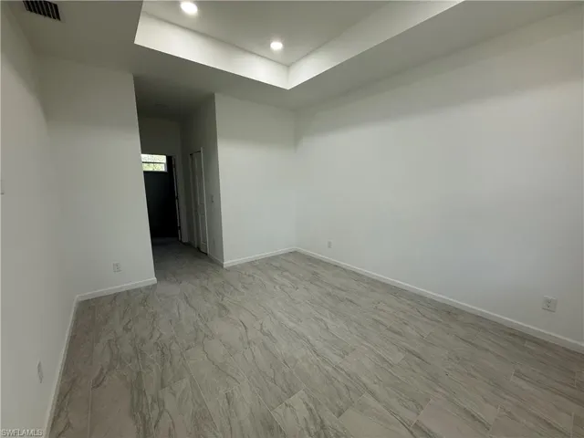 Empty room with baseboards and recessed lighting