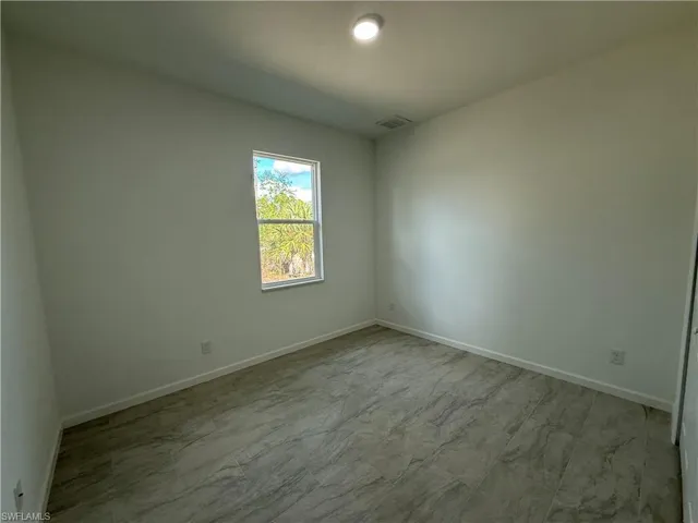Unfurnished room with baseboards