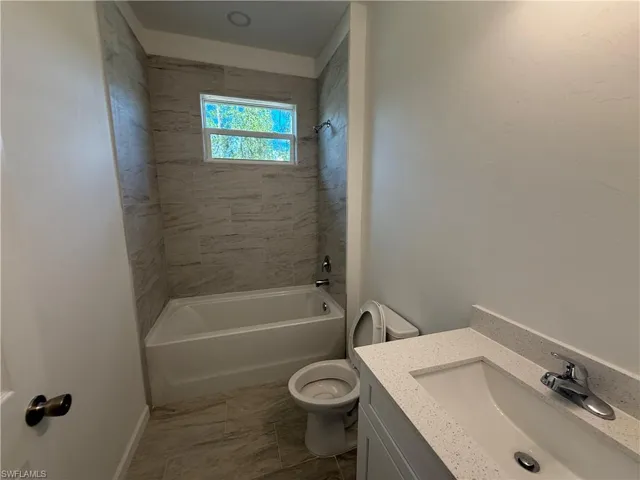 Full bath featuring  shower combination and vanity