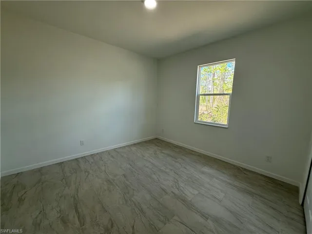 Spare room featuring baseboards