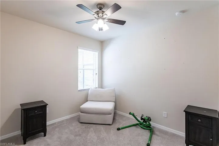 Living area with carpet and ceiling fan