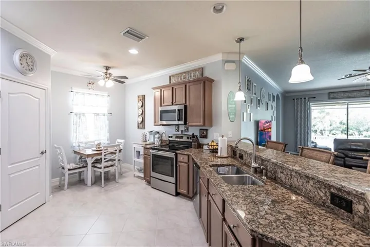 Kitchen with ceiling fan, stainless steel appliances, a wealth of natural light, and sink
