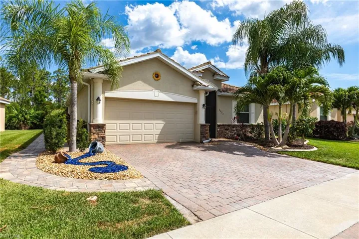 View of front of house featuring a garage and a front lawn
