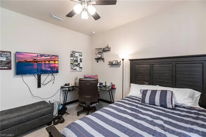 Bedroom with carpet and ceiling fan