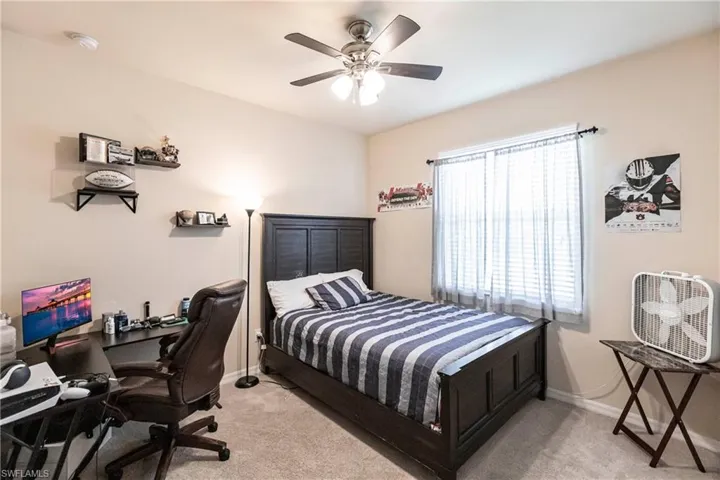 Bedroom featuring light colored carpet and ceiling fan