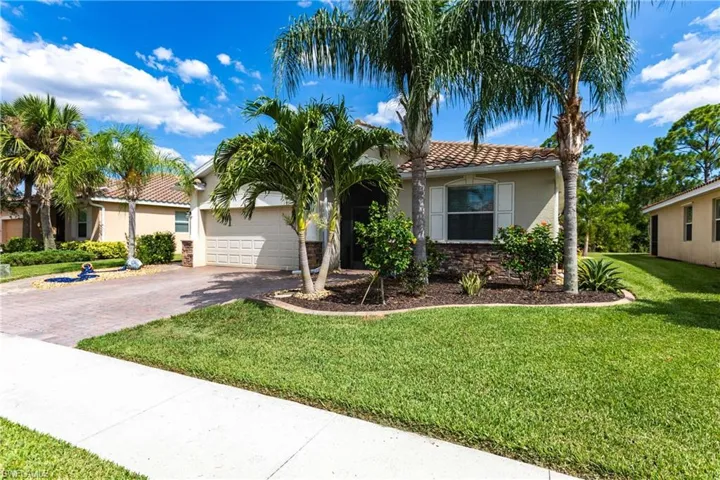 Mediterranean / spanish house with a front lawn and a garage
