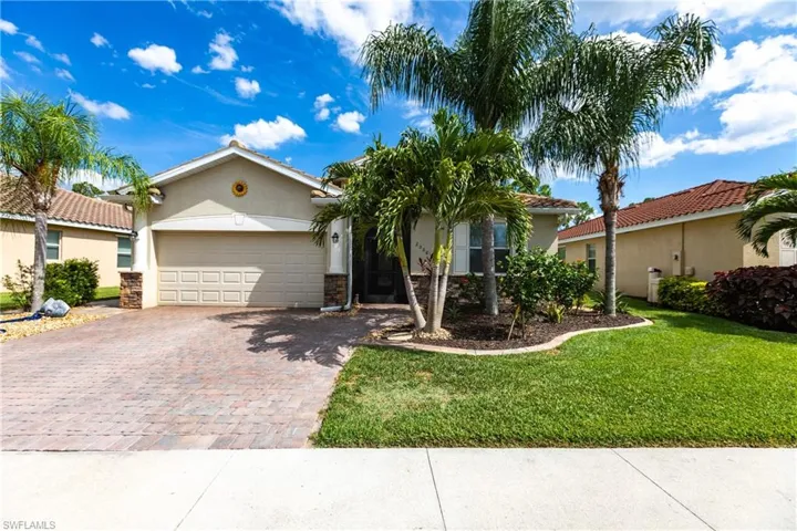 View of front of home featuring a garage and a front lawn