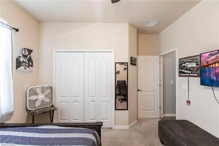 Bedroom with a closet, carpet floors, and ceiling fan