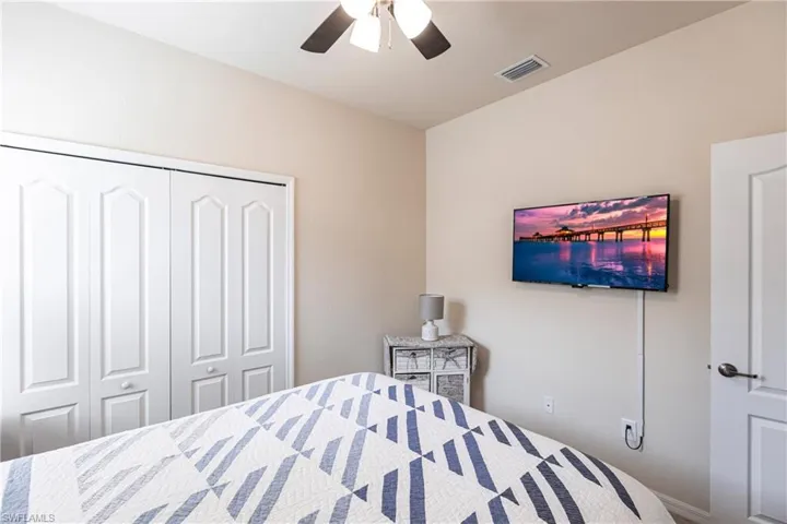 Bedroom featuring ceiling fan and a closet