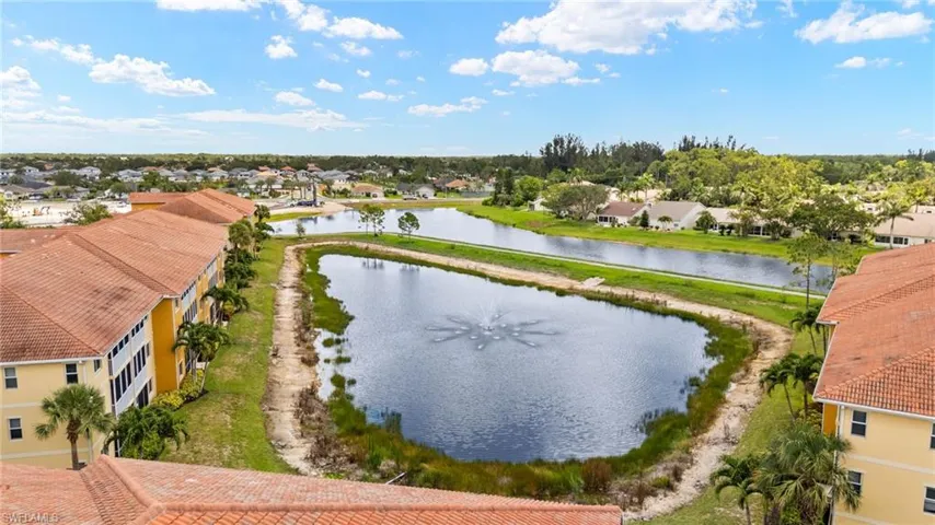 Aerial view of residential area featuring a large body of water