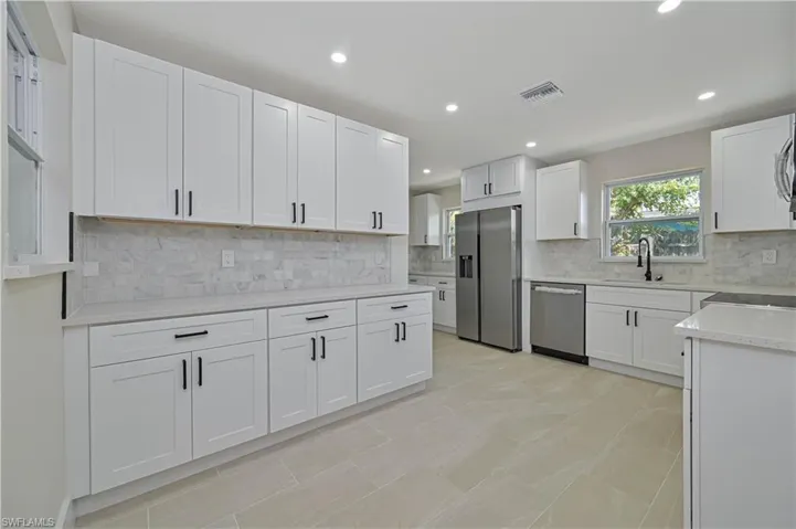 large kitchen with tons of cabinets and countertop