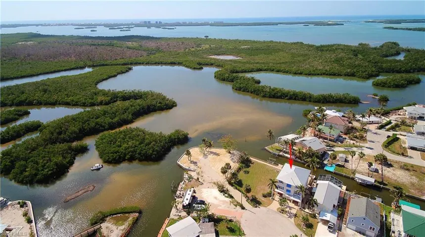 Birds eye view of property with a water view