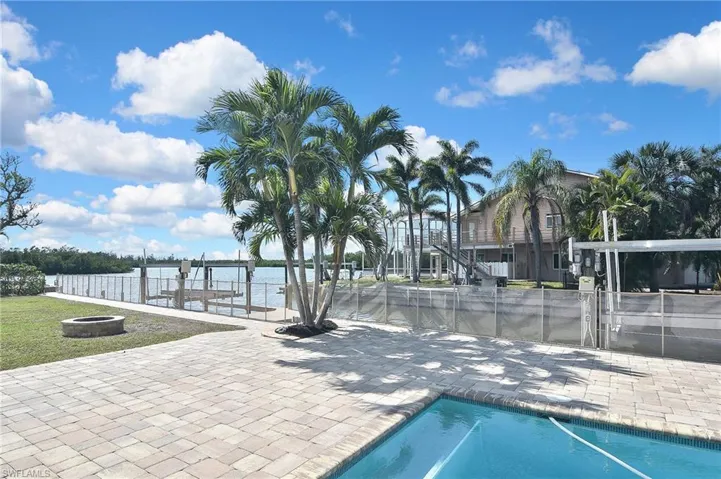 View of swimming pool featuring a patio and a water view