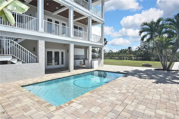 View of pool with a yard, a patio, and an outdoor kitchen