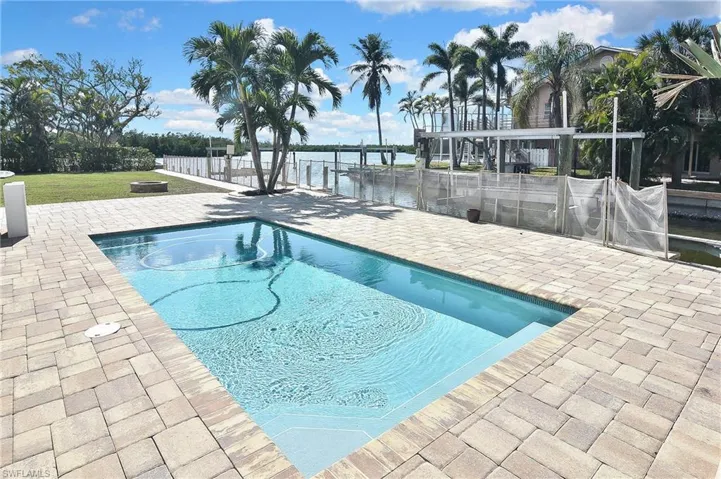 View of swimming pool featuring a patio area and a water view