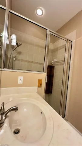 Full bathroom featuring vanity, a stall shower, and recessed lighting