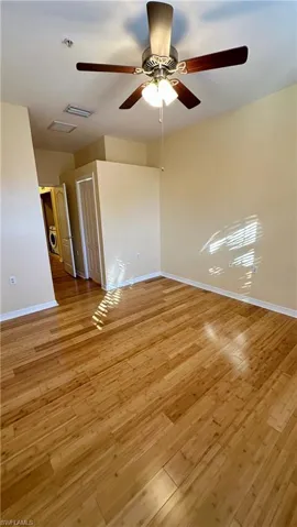 Empty room with light wood-style flooring and a ceiling fan