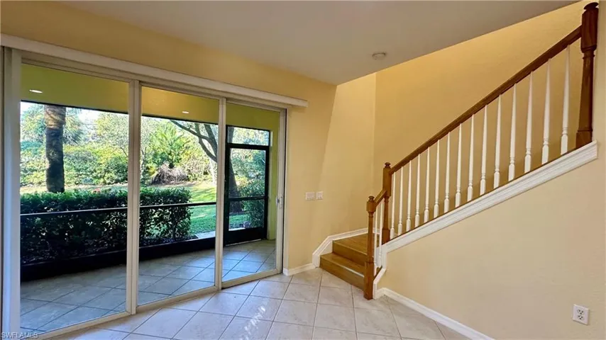 Doorway featuring stairs and tile patterned floors