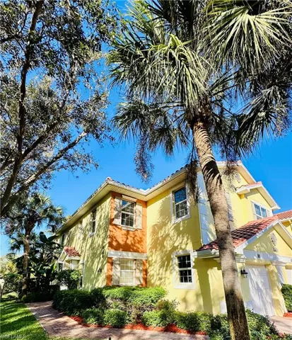 View of property exterior featuring stucco siding and a tiled roof