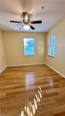 Spare room featuring light wood-style floors and ceiling fan