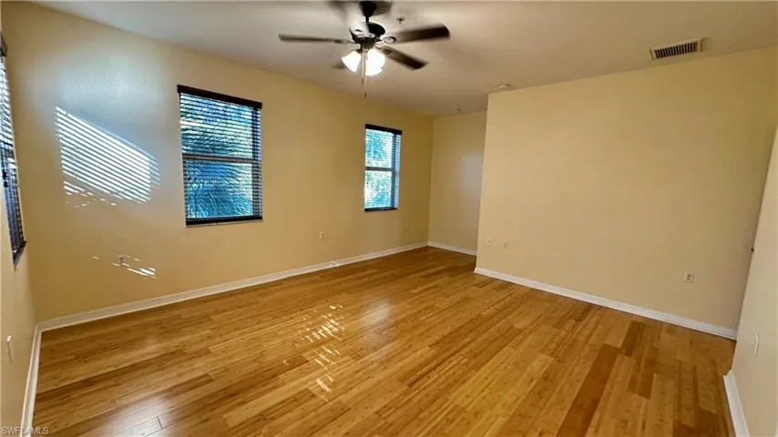 Empty room with light wood-style flooring and a ceiling fan