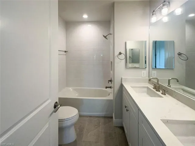 Bathroom featuring shower / bath combination and double vanity