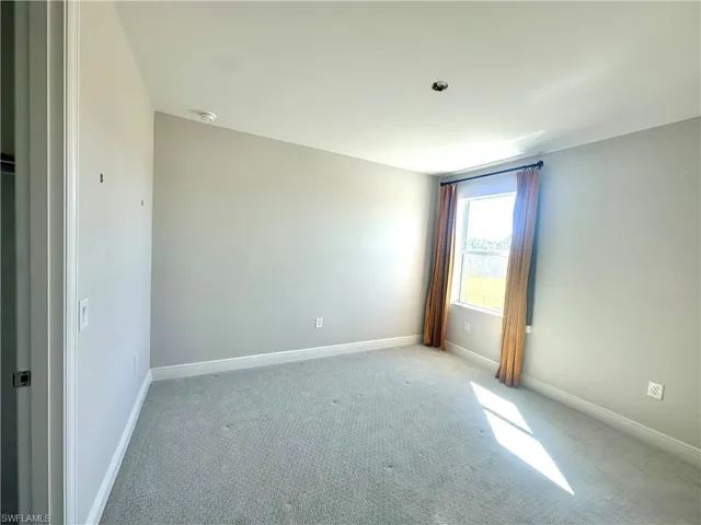 Empty room with carpet floors