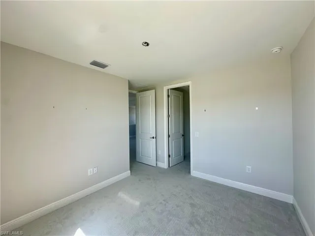 Unfurnished bedroom with baseboards and carpet