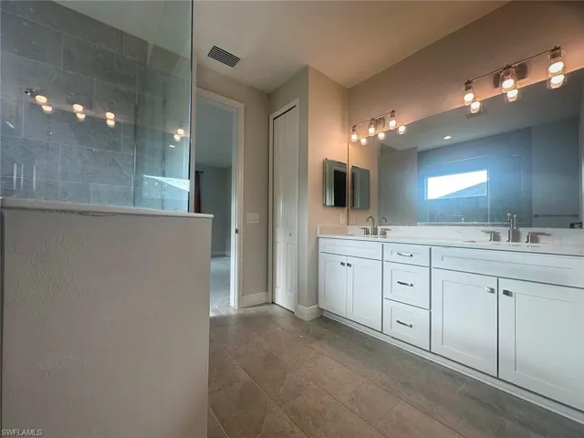 Bathroom with double vanity and a walk in shower