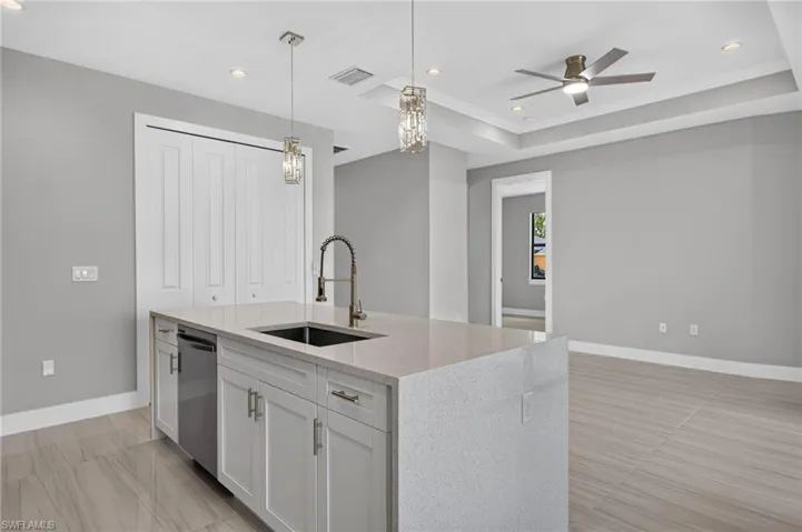 Contemporary kitchen island with a quartz countertop and integrated sink