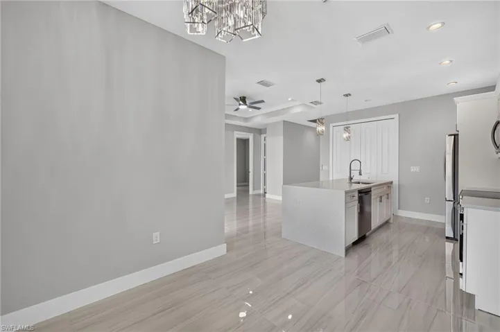 Open-concept living space with large format tile flooring throughout