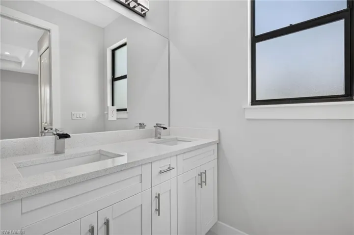 Dual integrated sinks with chrome faucets set in a light speckled countertop