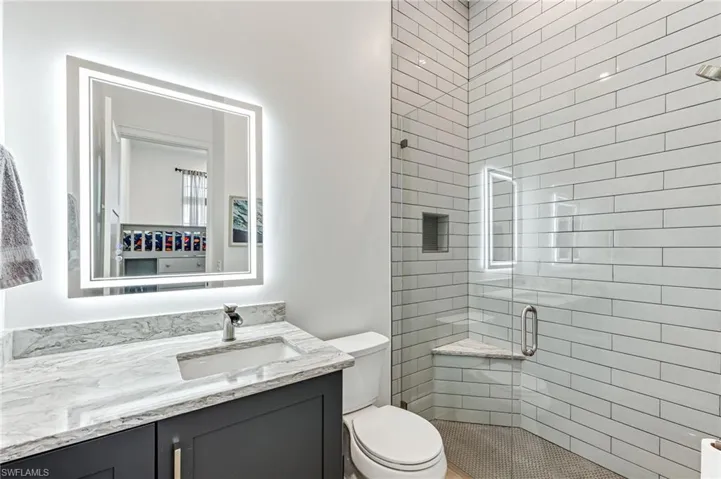 Bathroom featuring a stall shower and vanity
